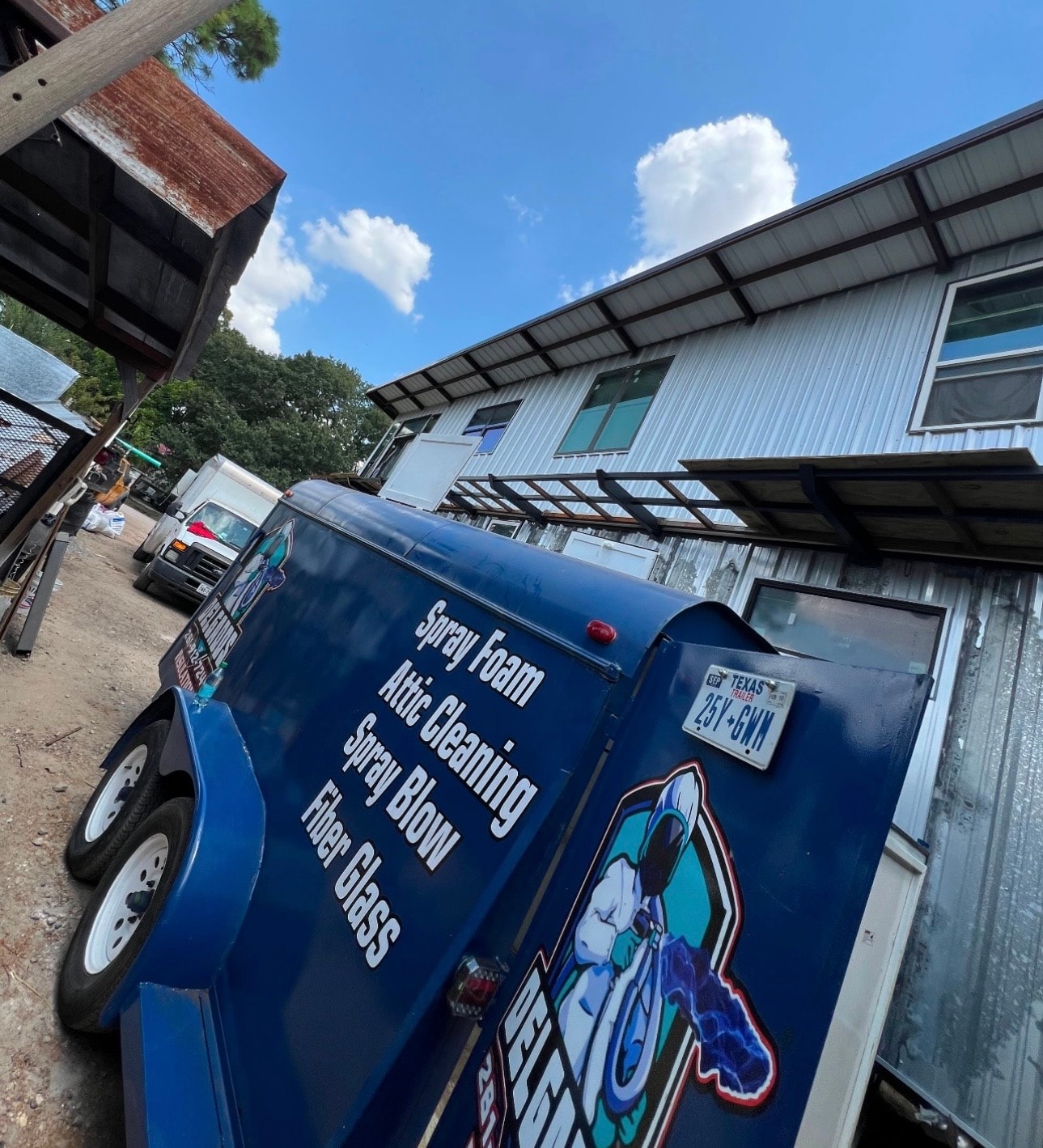Delgados Insulation service trailer — Spray Foam, Attic Cleaning, Spray Blow, and Fiber Glass services.